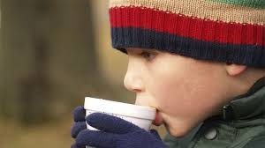 kid sipping hot chocolate