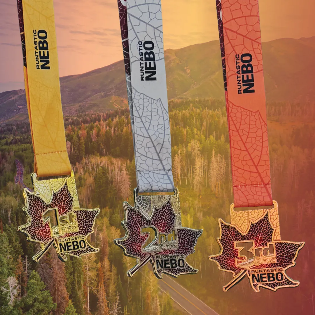 Three Runtastic NEBO 2026 Award Medals in front of Mt NEBO in Payson, Utah